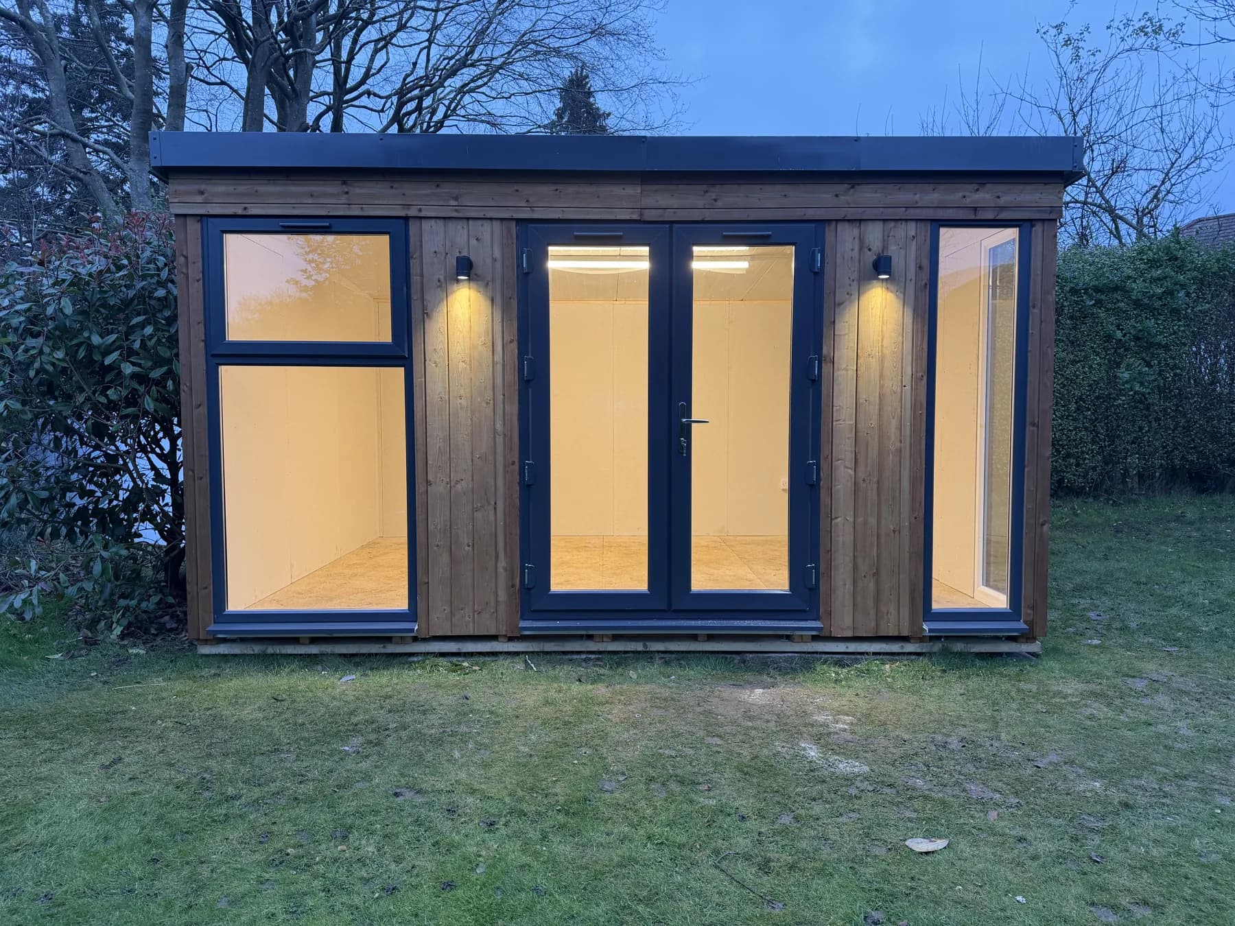 The garden room illuminated in the evening.