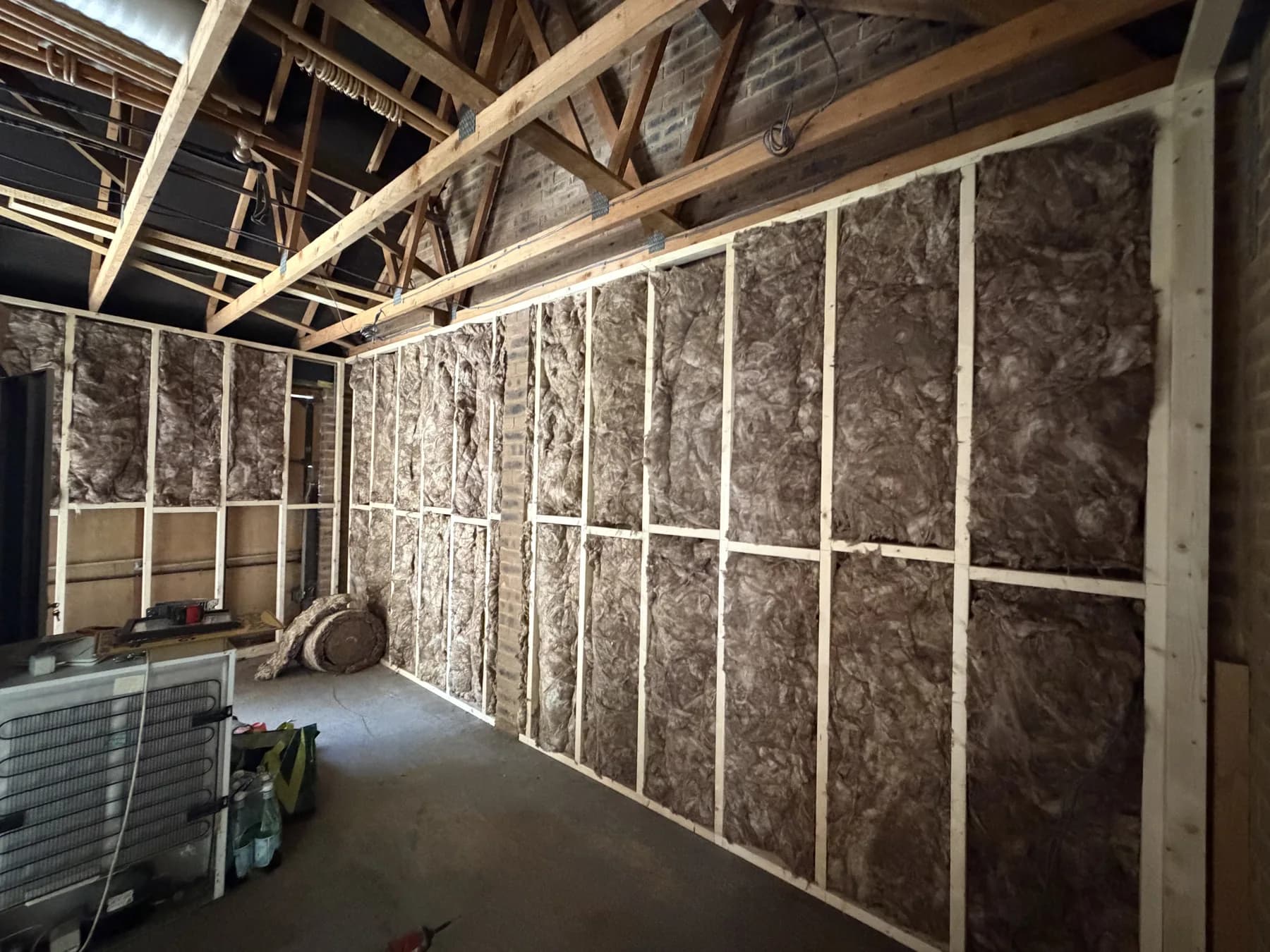 During construction — timber framing and wall insulation.