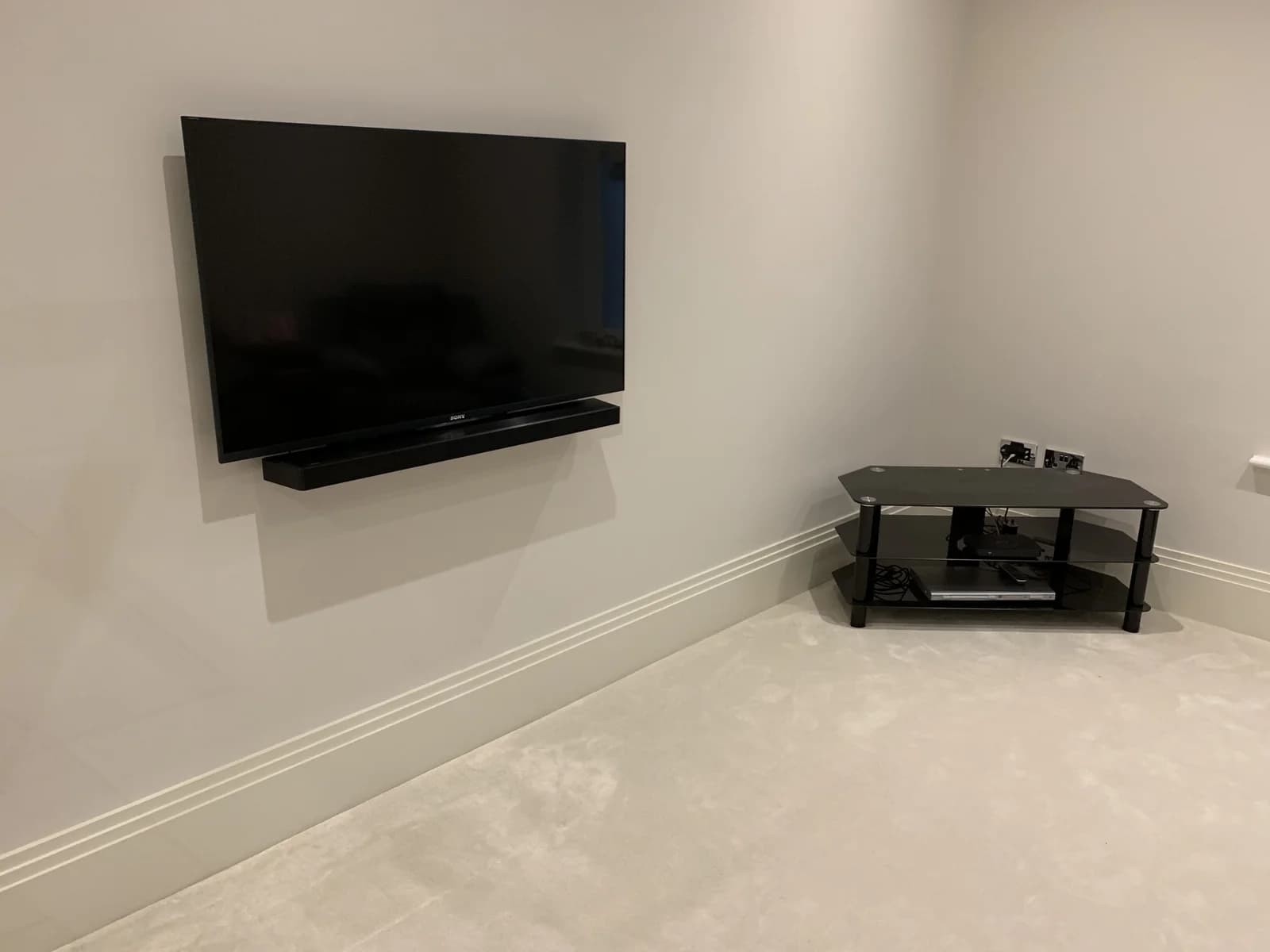 Wall-mounted television in a freshly finished room