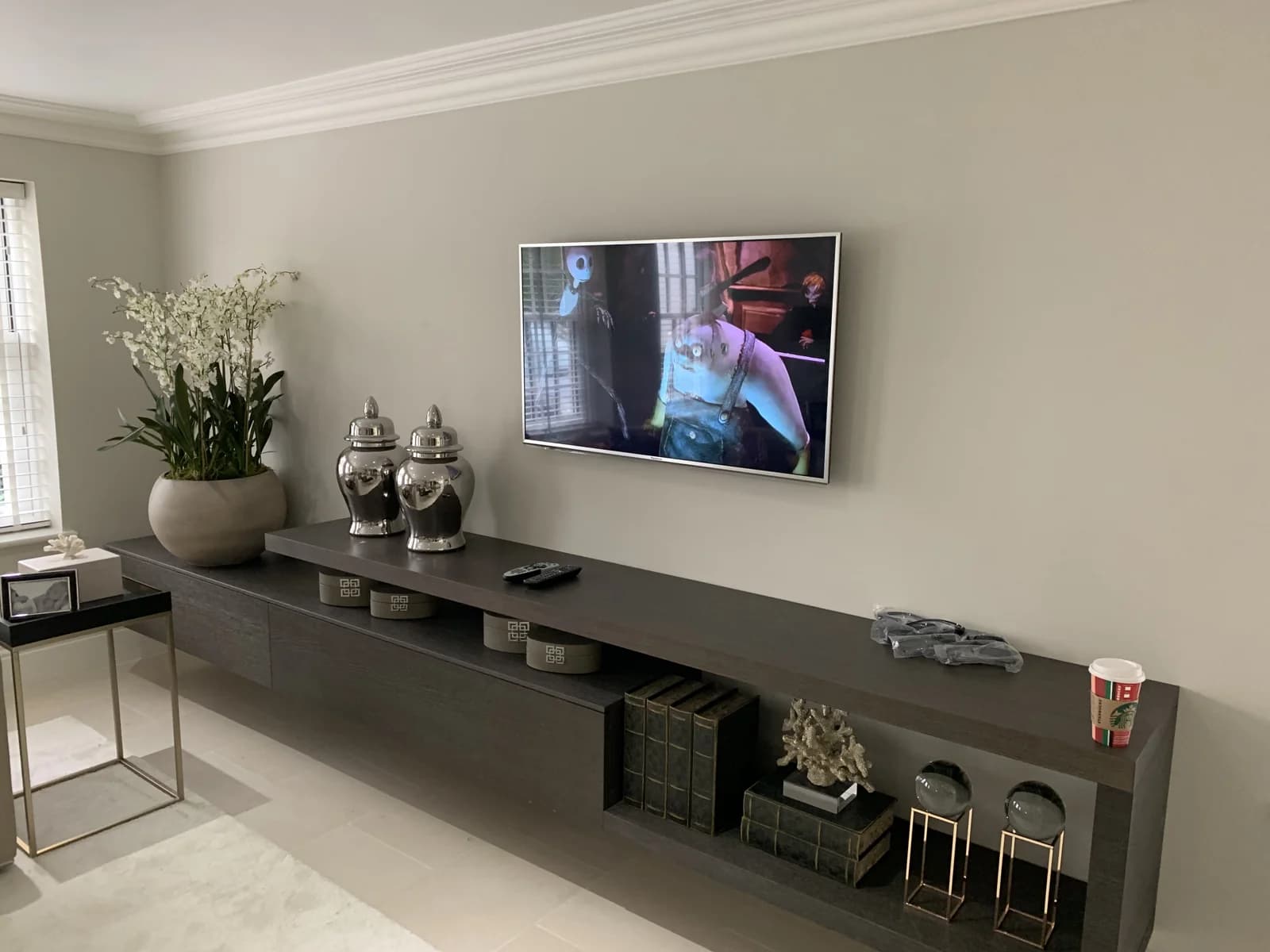 TV mounted neatly above a low cabinet in a customer's living room