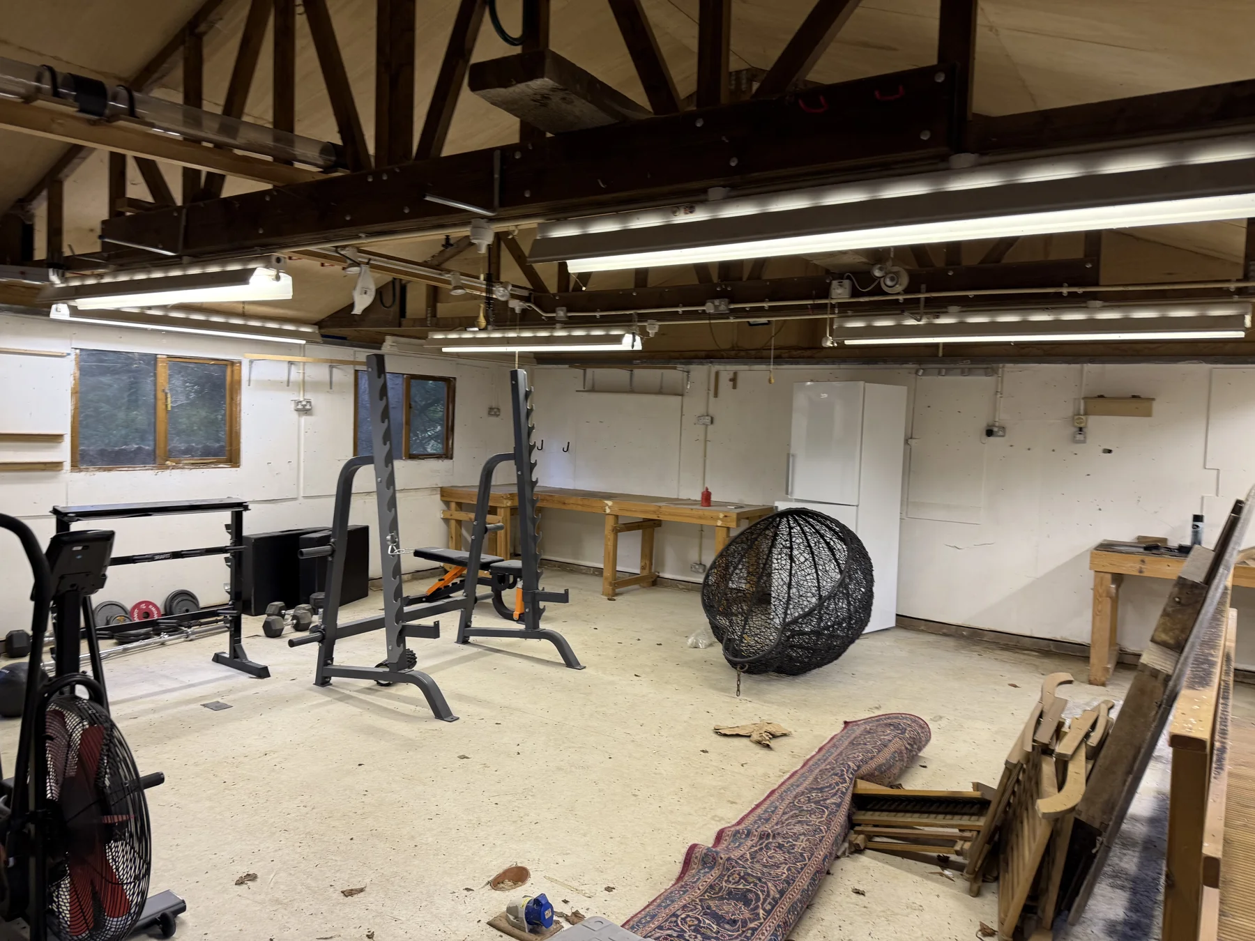 Before — the original room with workbenches and unfinished surfaces.