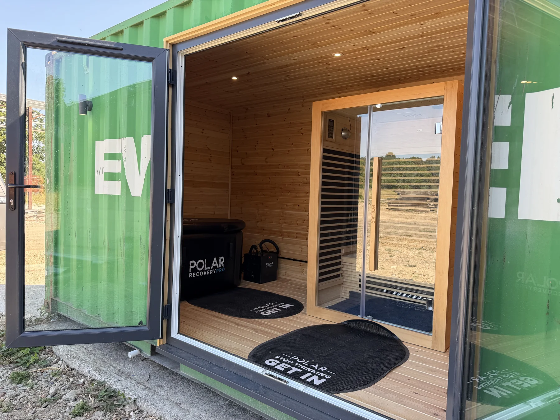 Container recovery room with a glazed entrance and timber-lined interior.