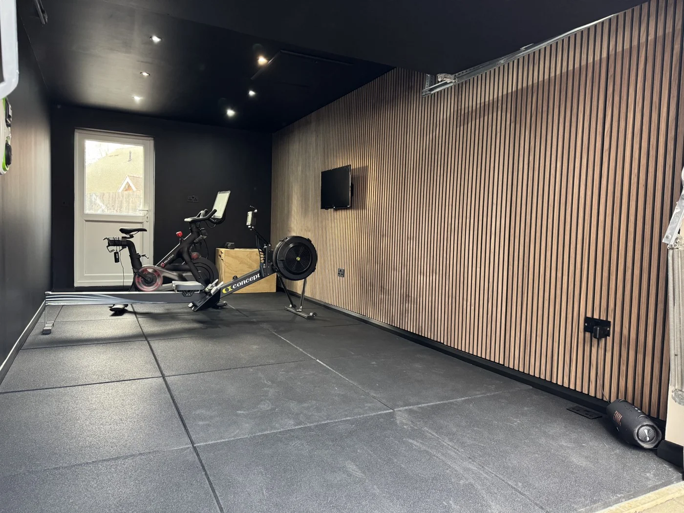 Panda Projects garage gym with vertical cladding and a black finish