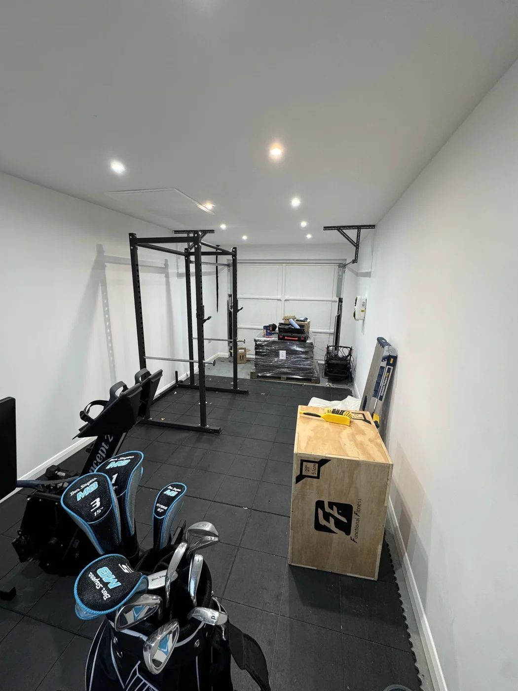 Earlier stage — white walls before the black finish and cladding.