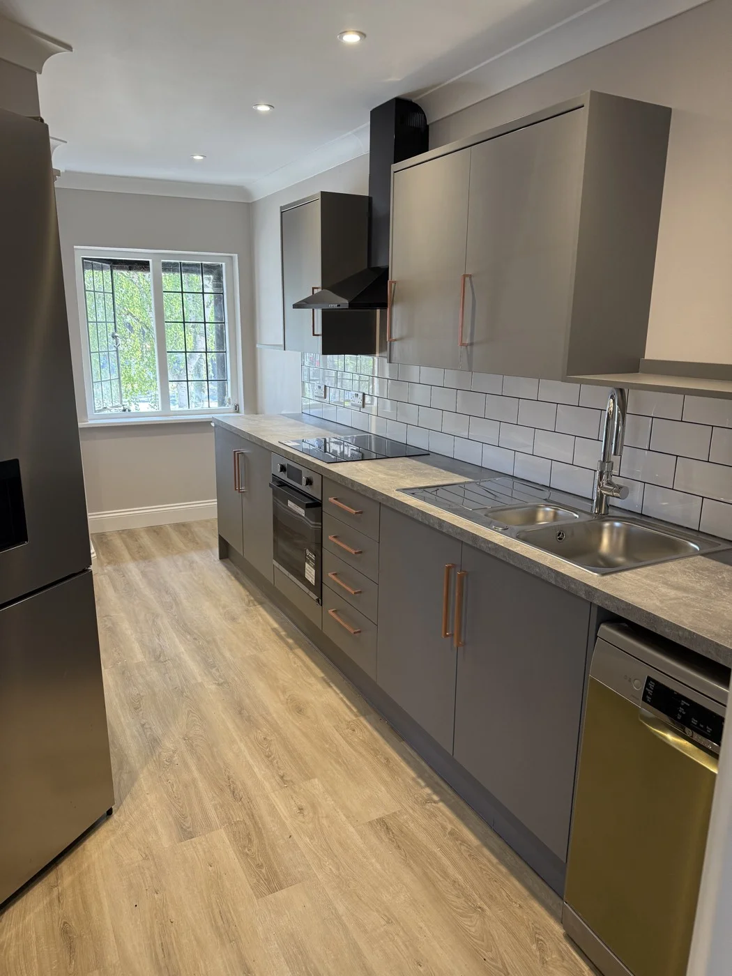 The relocated office kitchen with new cabinetry and flooring.